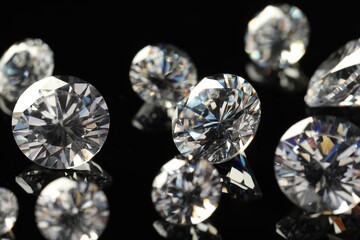 Many beautiful shiny diamonds on black mirror surface, closeup