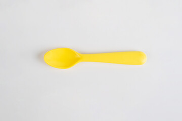 Yellow spoon isolated on white background.
