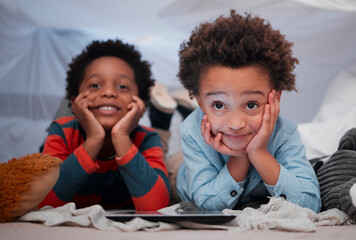 Boy, children and smile with tablet in home for playing educational games and web subscription at sleepover. Blanket fort, friends and digital app for streaming movie, cartoon and video entertainment