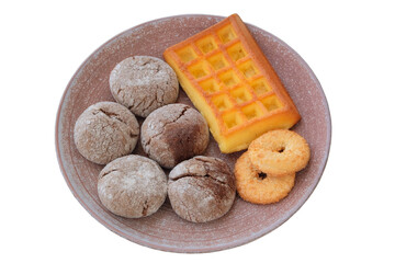 Variety of cakes and waffle in ceramic plate isolated on a white background. Golden romantic biscuit.