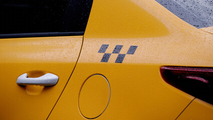 taxi checkers on a yellow car
