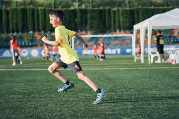 Boy Running on Soccer Field