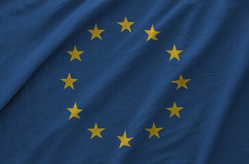 European union flag depicted on folded wavy fabric of old cloth close up