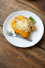 Crispy fried bananas topped with cheese, highlighting a delicious and indulgent treat, perfect for food, dessert, and culinary