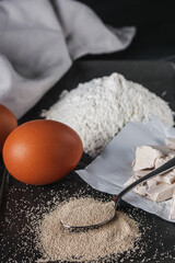 Granulated dry yeast on a dark rustic background