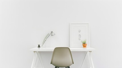 A white desk with a lamp and a framed white picture
