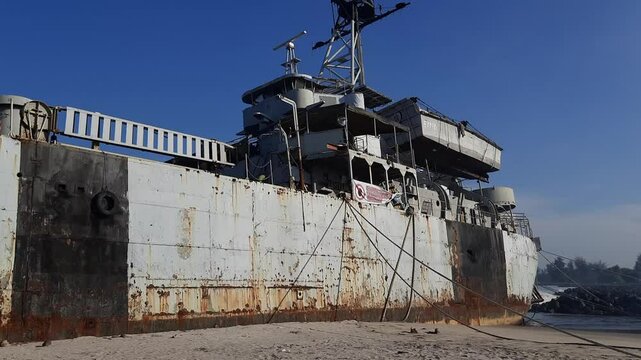 an old historical Indonesian warship landed on the beach in the city of Pariaman