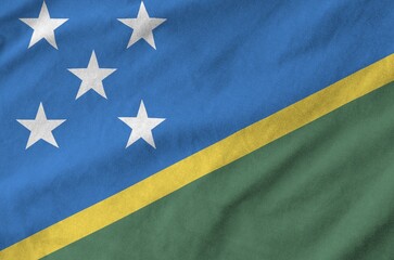 Solomon Islands flag depicted on folded wavy fabric of old cloth close up