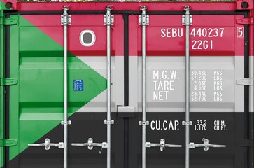 Sudan flag depicted on metal doors of shipping cargo container outdoors in docks area close up