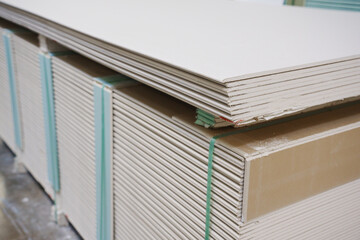 gypsum board on a rack in a hardware store. sale of building materials for repair and construction.
