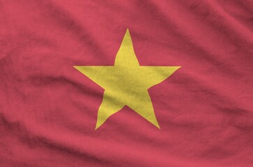 Vietnam flag depicted on folded wavy fabric of old cloth close up