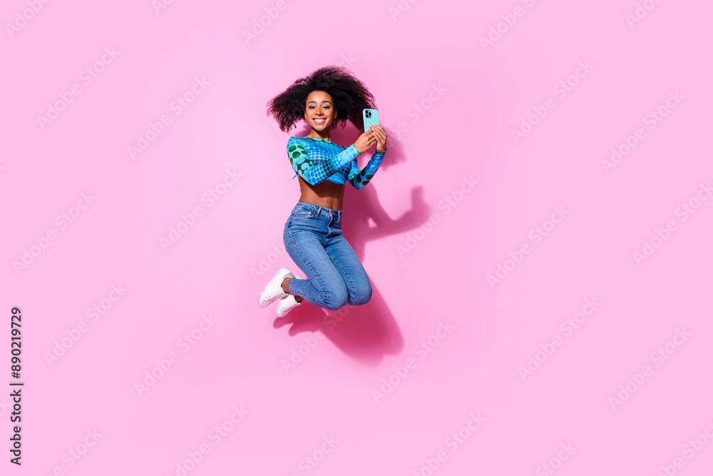 Canvas Prints Full size photo of pretty young girl jump running hold telephone wear trendy blue outfit isolated on pink color background