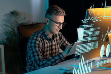 Man In Glasses And Plaid Shirt Analyzing Data On Digital Interface In Modern Office Setting,...
