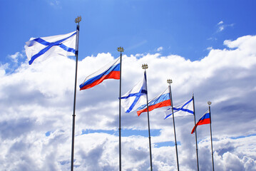 The Russian flag flutters in the wind against the blue sky, Background.	