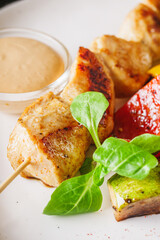 barbecue chicken and vegetables on a white plate