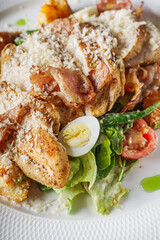 delicious fresh caesar salad with chicken cherry tomatoes and quail eggs