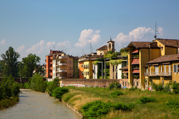 Old riverside buildings in Parma city, historical architecture photography