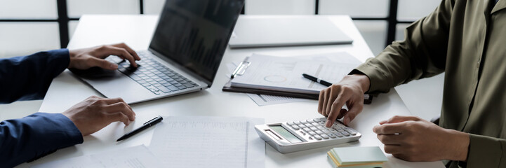 Business administrator calculates profit in a conference room