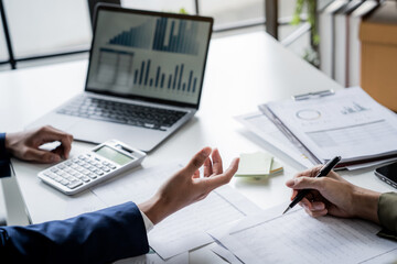 Business administrator calculates profit in a conference room