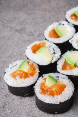 delicious fresh futomaki sushi roll with salmon and avocado