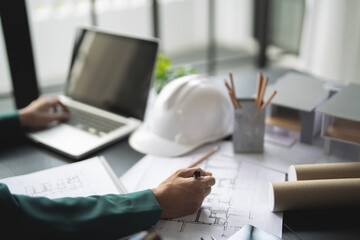 Architects interior designer hands working with Blue prints and documents for a home...