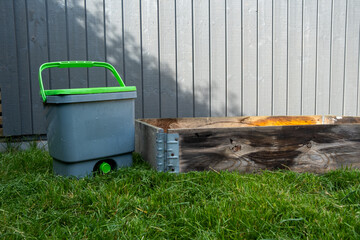 Bokashi bucket on the lawn with pallet for composting foodscraps to nutrient soil with bio char