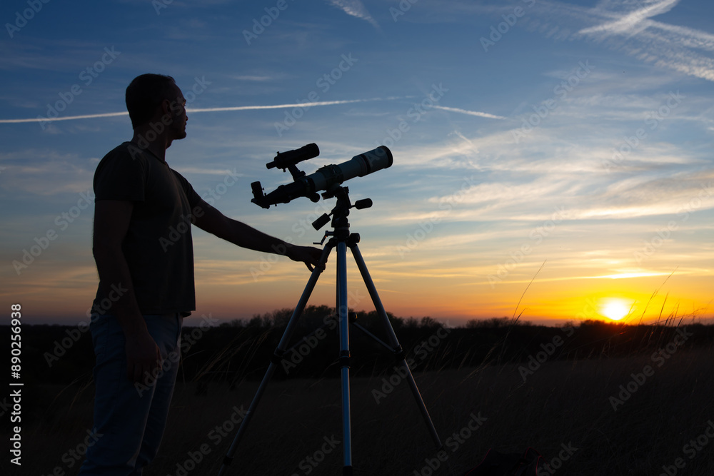Canvas Prints amateur astronomer observing solar eclipse and sun with a telescope and special solar filter.