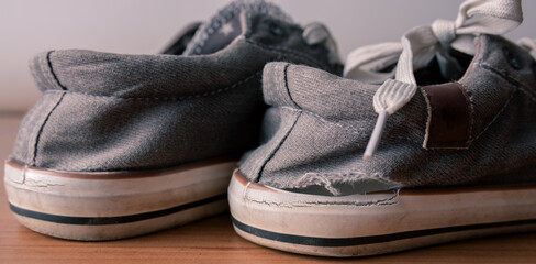 A close-up shot of a worn-out pair of shoes, symbolizing the challenges of poverty