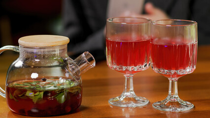 Fruit or berry tea in a glass bowl. Freshly brewed natural tea ceremony process, healthy morning, detox drink.