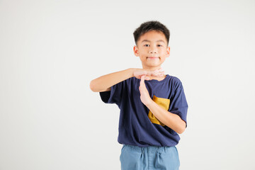 Closeup portrait young kid boy smiling making give time out gesture with hands studio shot isolated on white background, primary child demonstrates break hand sign, stop time with copy space