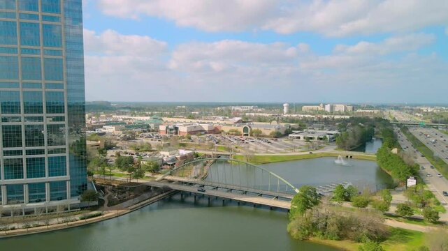 Push in establishing aerial shot of the Woodlands bridge next to the Allison Tower toward the Woodlands mall. Drone shot of the Woodlands bridge next to the interstate 45