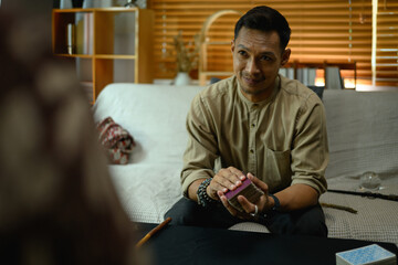 Fortune teller forecasting predicting future for man client. Forecasting and divination concept