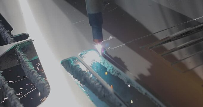Plasma cutting. Plasma cutter work at the factory. The plasma cutter will cut the part. The process of cutting a metal part with a plasma cutter