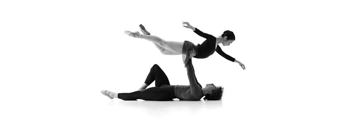 Banner. Graceful and poised, duo refines their routine in sync against white studio background....