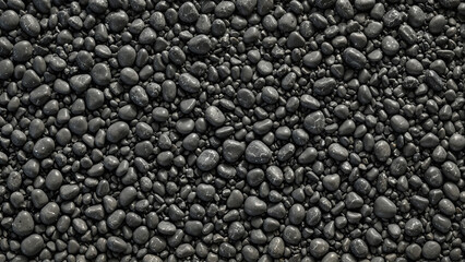 Grey smooth round sea pebbles and various stones closeup texture pattern. Dark naturally rounded gravel at sea shore background for your design. Decorative beach stones or gravel. Pebble texture