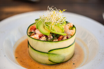 mexican ceviche of fish and shellfish marinated in citrus and seasonings deliciously served wrapped in cucumber thin slices