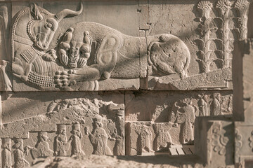 Bas-relief carvings of a lion hunting a bull in Persepolis, the Persian capital dating from about 500 B.C., and a UNESCO World Heritage Site located in northeast of Shiraz, Iran