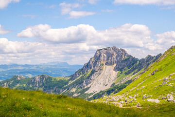 Mountain range against blue sky with clouds in background