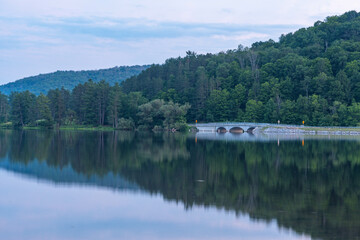 Setting sun low light long exposure over mountain lake summer season background image