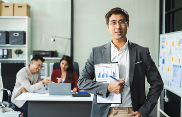 Smiling confident mature businessman leader looking at camera in office.