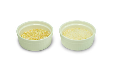 Khao Khua, Roasted uncooked rice whole and ground in white ceramic cups isolated on white background with clipping path closed up. Roasted uncooked rice associated with rustic cuisine