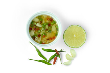 Nham Pla Prik, Thai sauce fresh chili peppers mixed with fish sauce garlic and lime, in white cup isolated on white background with clipping path top view flat lay. All purpose.flavour enhancer.