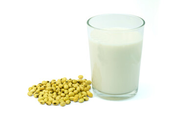 A glass of soy milk or soybean milk and heap of soy beans isolated on white background with...