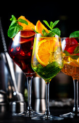 Summer sangria cocktails with spanish wine, fruits, citrus and ice. Black background