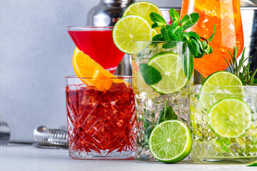 Popular summer cocktail drinks: aperol spritz, negroni, mojito, gin tonic and cosmopolitan with bar tools