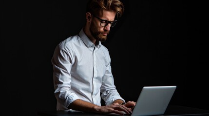 Man Working on Laptop in Dark Room