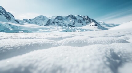 A breathtaking image of a snowy mountain landscape under a clear blue winter sky, capturing the serene and majestic beauty of a pristine, unspoiled natural environment.