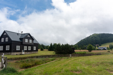 Tourist houses in a mountain village in the Czech Republic. Landscape of mountain village in summer on a sunny day. High quality photo 
