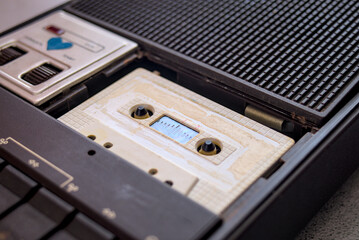 Compact cassette tapes and cassette recorder on the table.