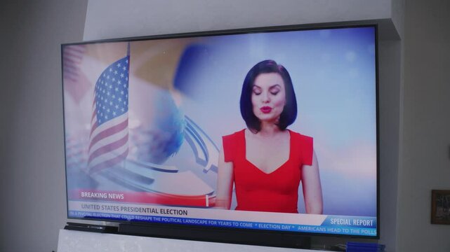 Close up shot of big flat screen TV monitor with displayed news about elections in United States of America. Female news anchor invites people to vote on national election day. TV live broadcast.